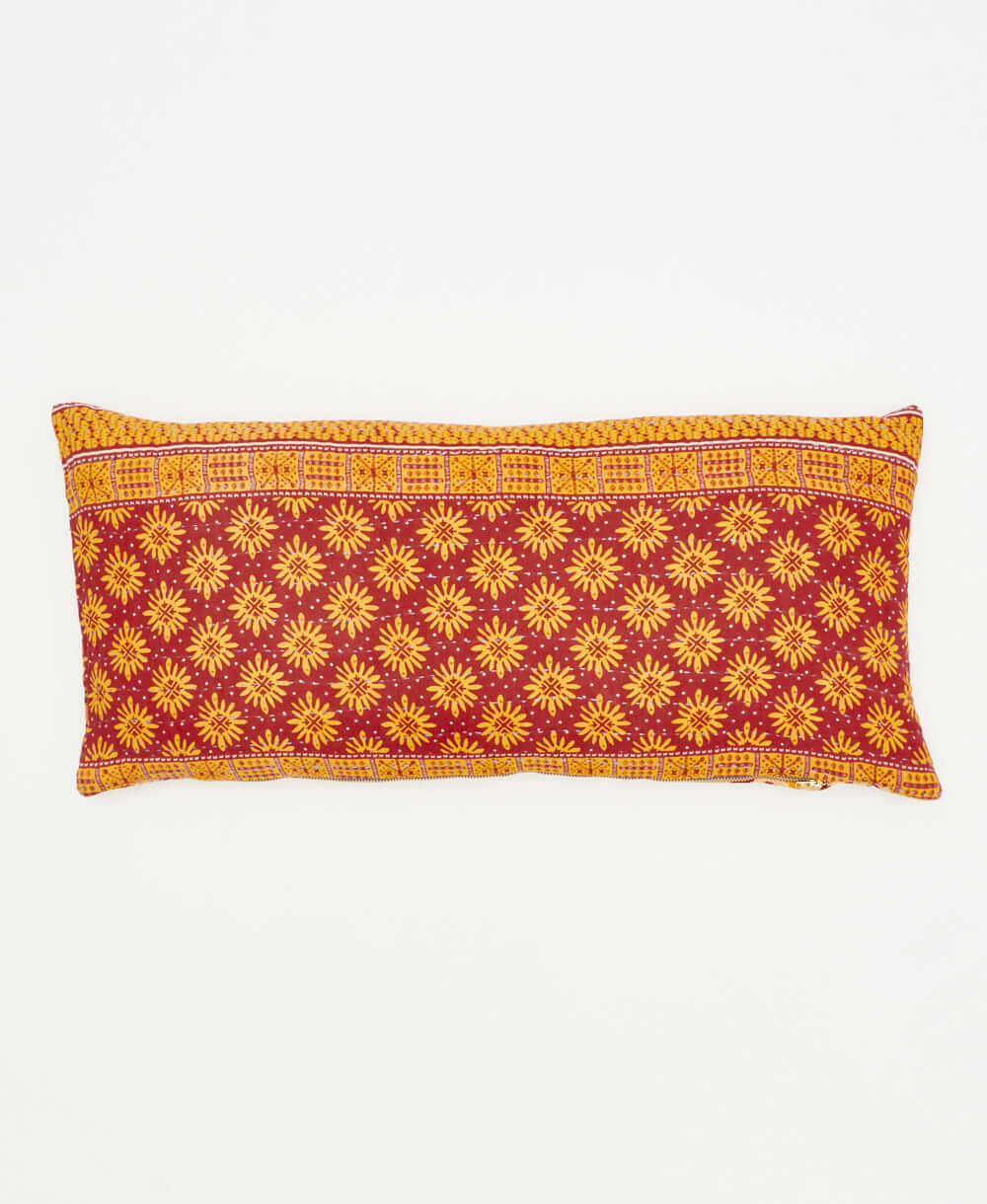 lumbar pillow featuring a marigold and maroon floral print 