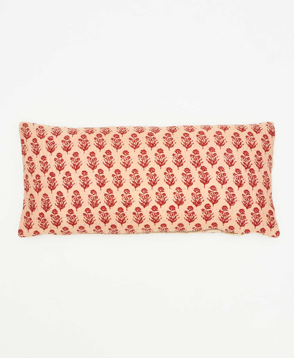 artisan made beige lumbar pillow featuring a maroon stamp floral print 