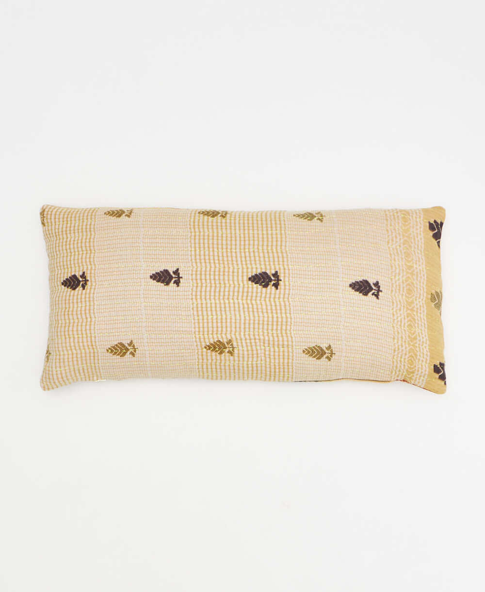 tan lumbar throw pillow with red and gold leaf print handmade in India by women artisans