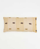 tan lumbar throw pillow with red and gold leaf print handmade in India by women artisans