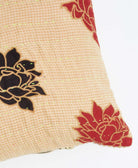 sustainable lumbar pillow in tan with red and black flowers with neon green embroidery