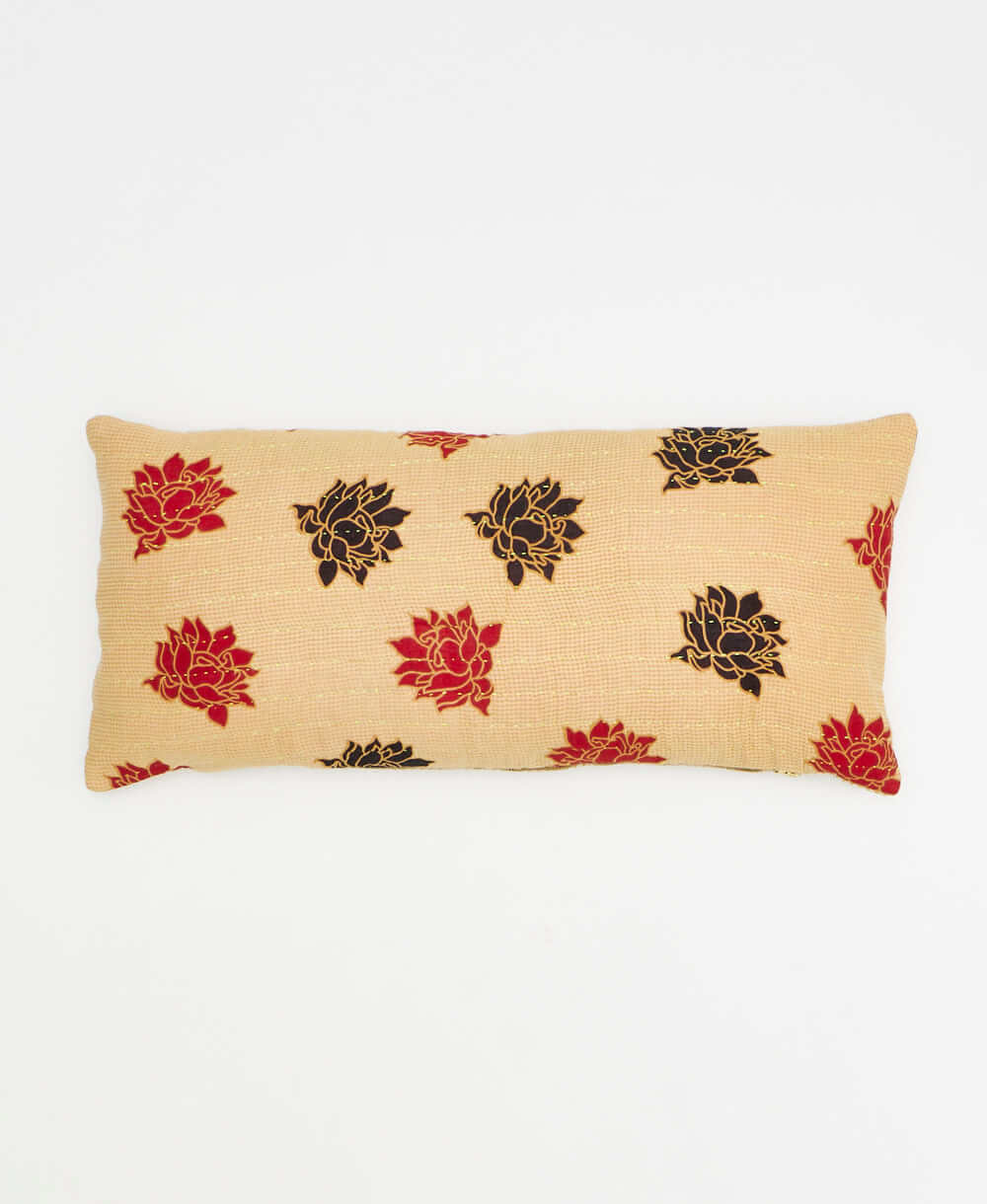 yellow-tan lumbar pillow with black and red flowers made from upcycled vintage cotton saris in India