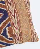 sustainable lumbar pillow in tan in navy and maroon ikat print with neon green embroidery