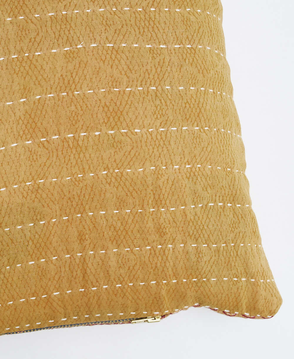 sustainable lumbar pillow in abstract yellow-tan print with white kantha embroidery