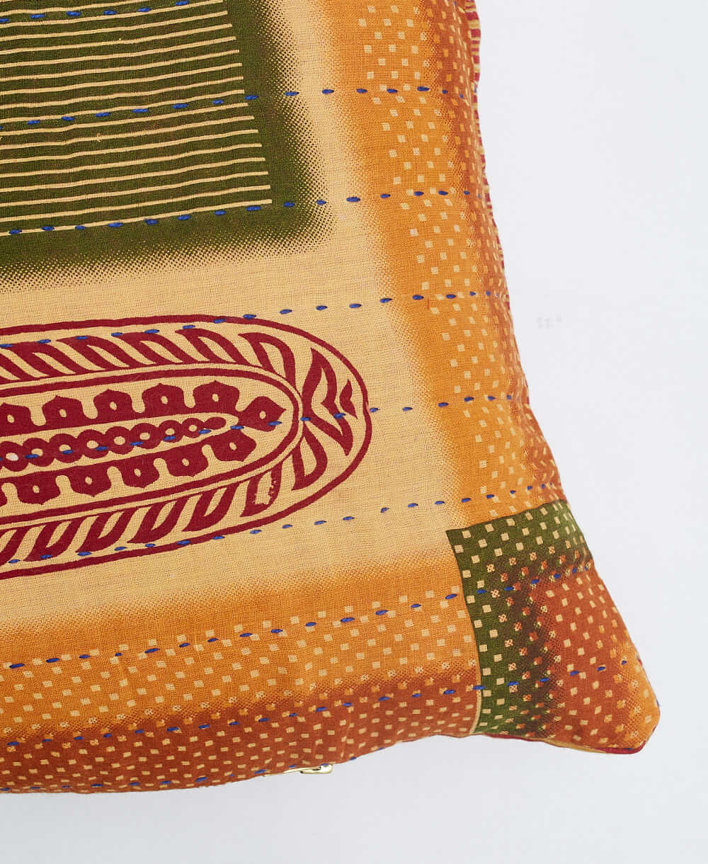 sustainable lumbar pillow in orange & olive abstract print with blue kantha embroidery