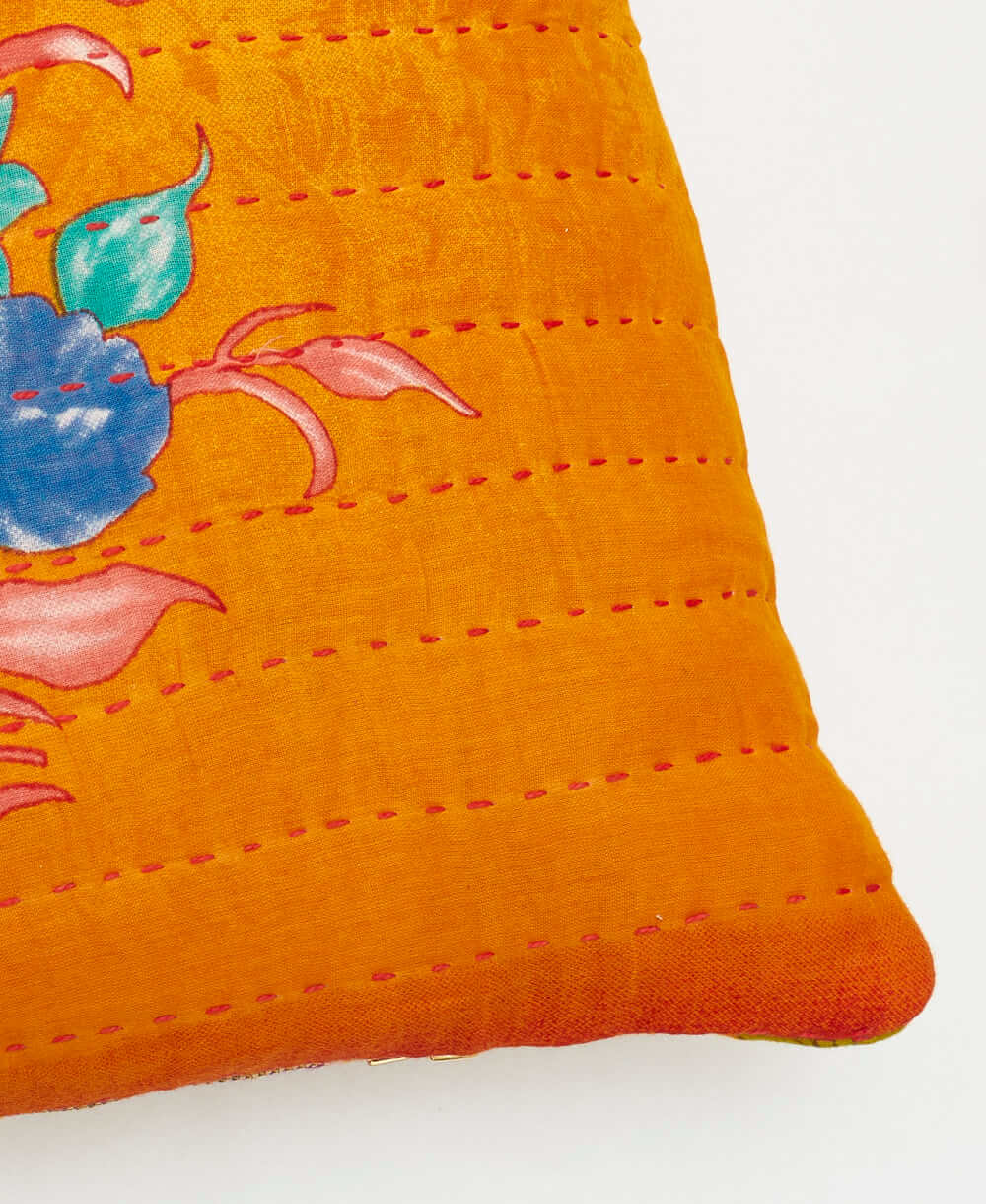 sustainable lumbar pillow in orange & blue bouquet print with red kantha embroidery