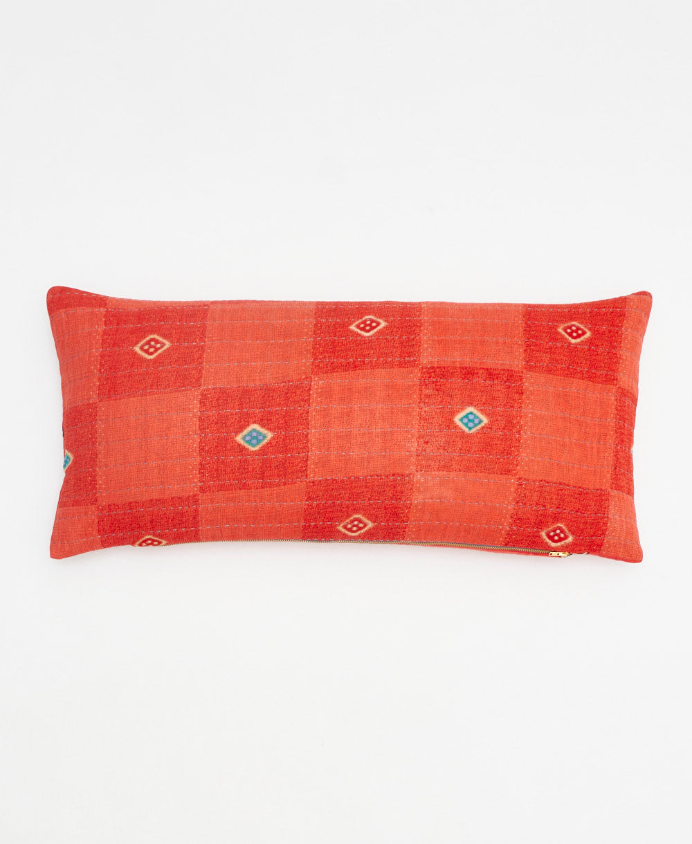 coral red lumbar pillow with a teal diamond print made from upcycled vintage cotton saris in India