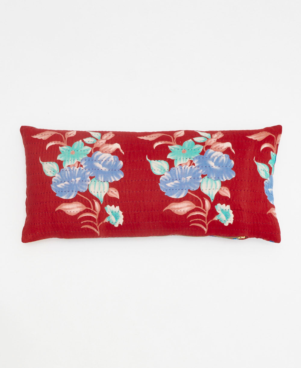 red lumbar pillow with a bold blue floral print made from upcycled vintage cotton saris in India