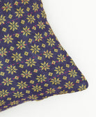 lumbar pillow in eggplant purple and yellow star print with pink kantha stitching