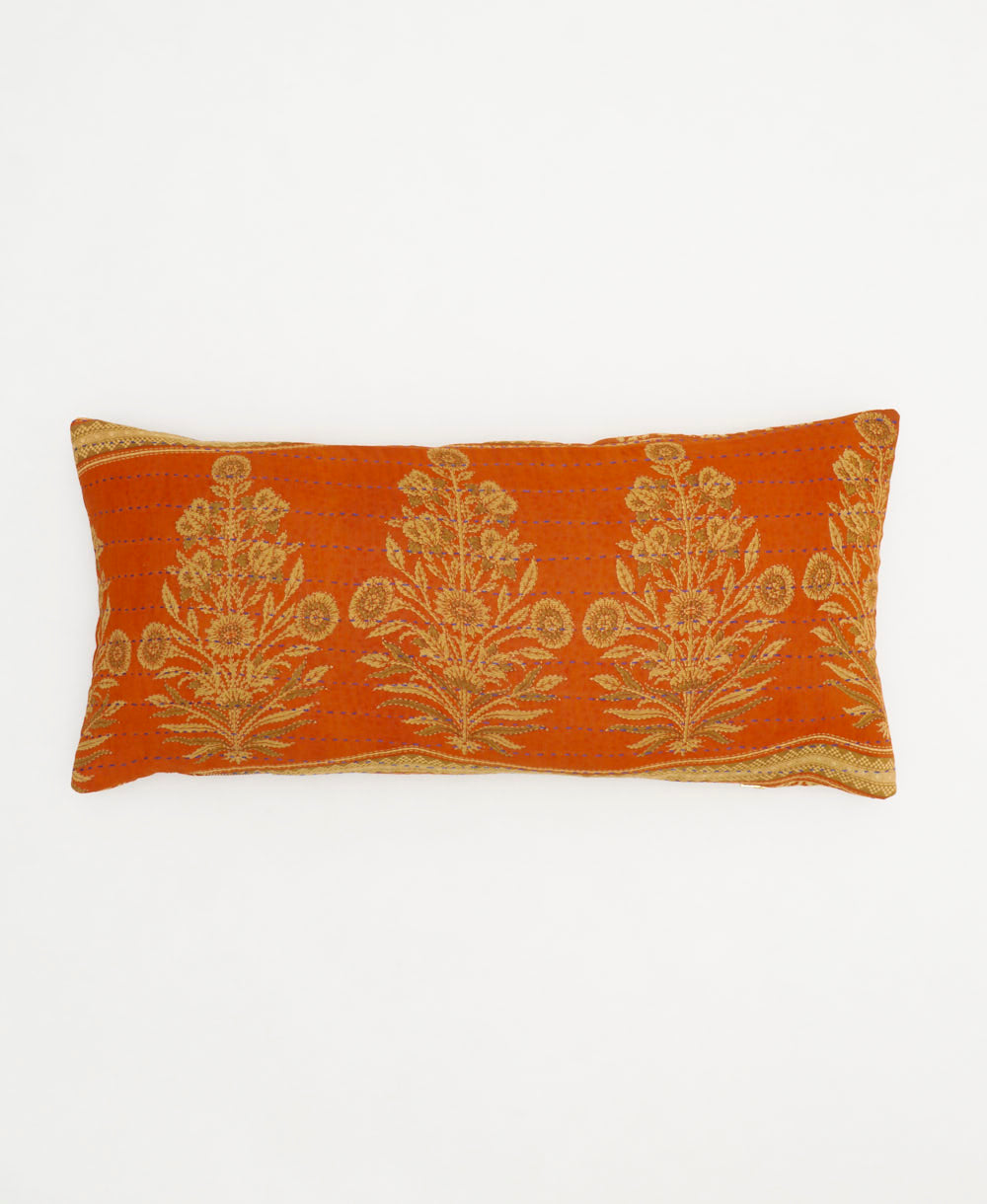 sunset orange lumbar pillow with beige marigold plant pattern