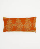 sunset orange lumbar pillow with beige marigold plant pattern