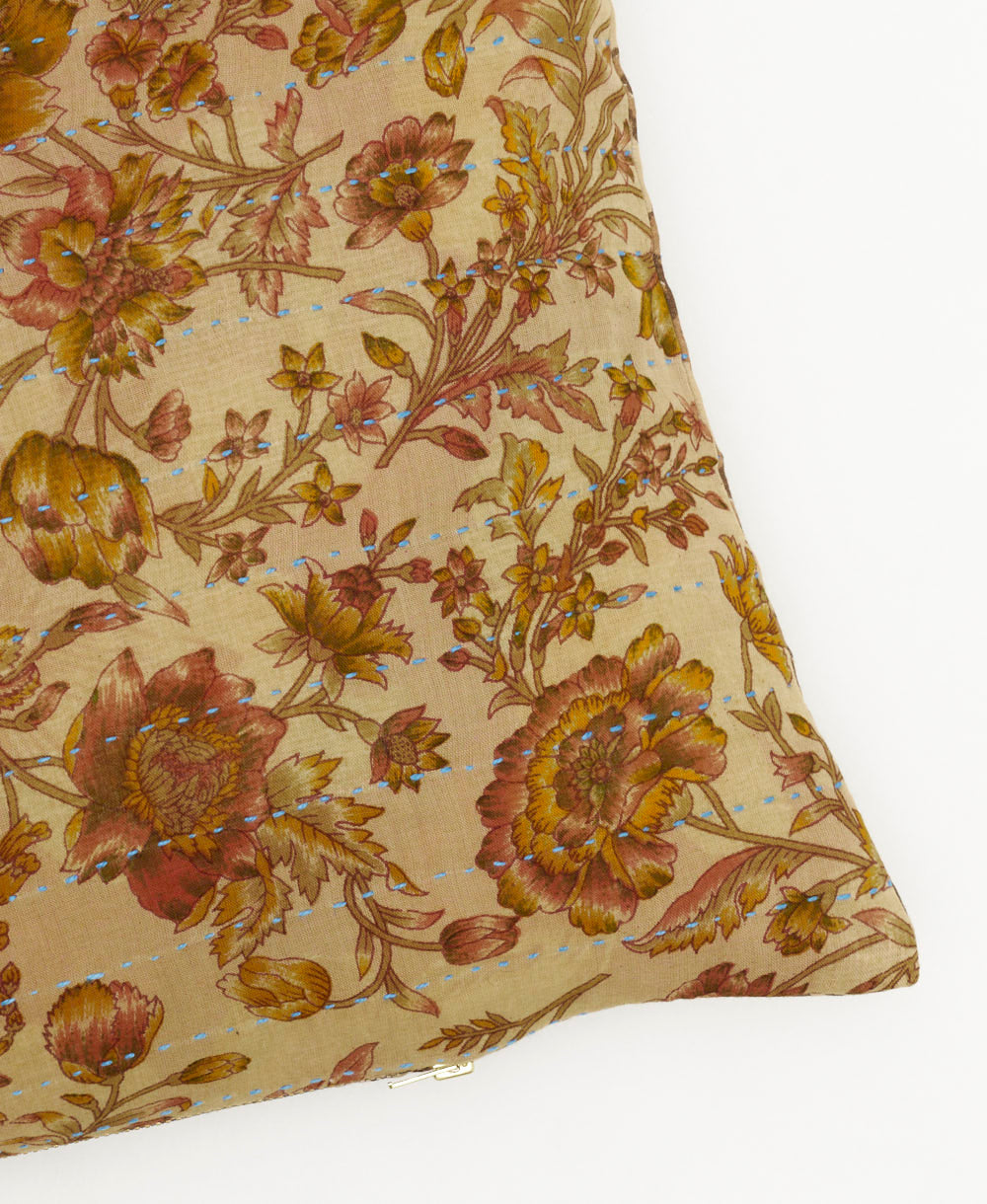 lumbar pillow in tan rose print with sky blue kantha stitching