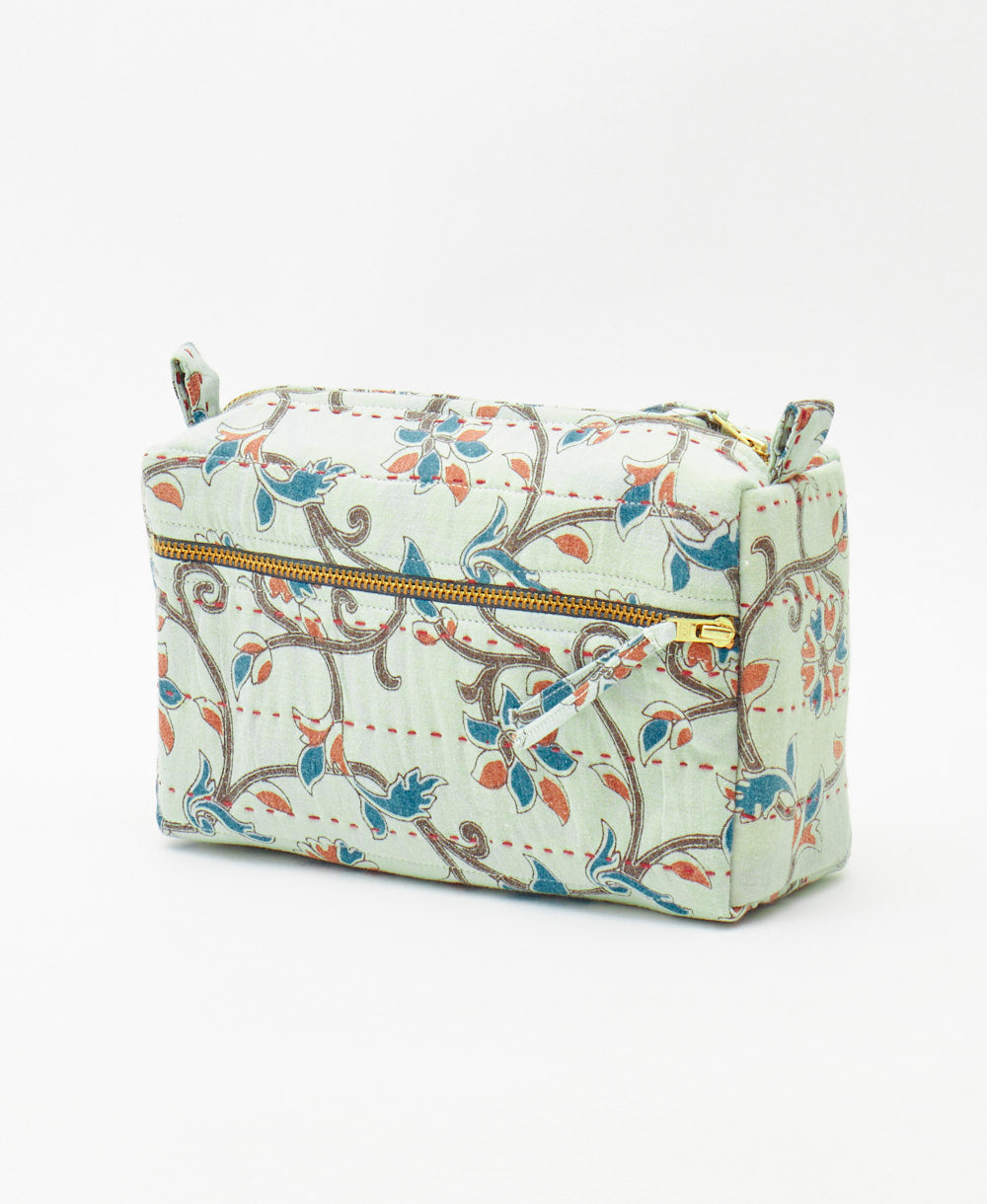 sky blue medium toiletry bag featuring an orange vine floral print and traditional kantha hand stitching 