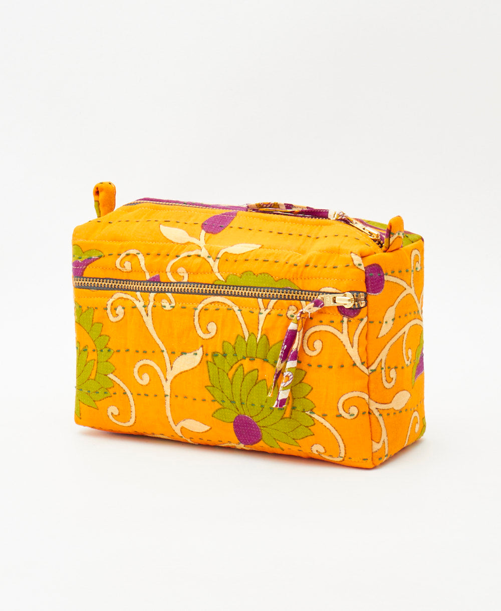 medium toiletry bag featuring a yellow and green floral print and green traditional kantha hand stitching 