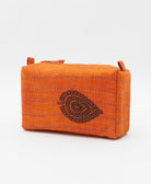 cosmetic travel bag in an orange & black leaf print with blue hand-stitched kantha embroidery