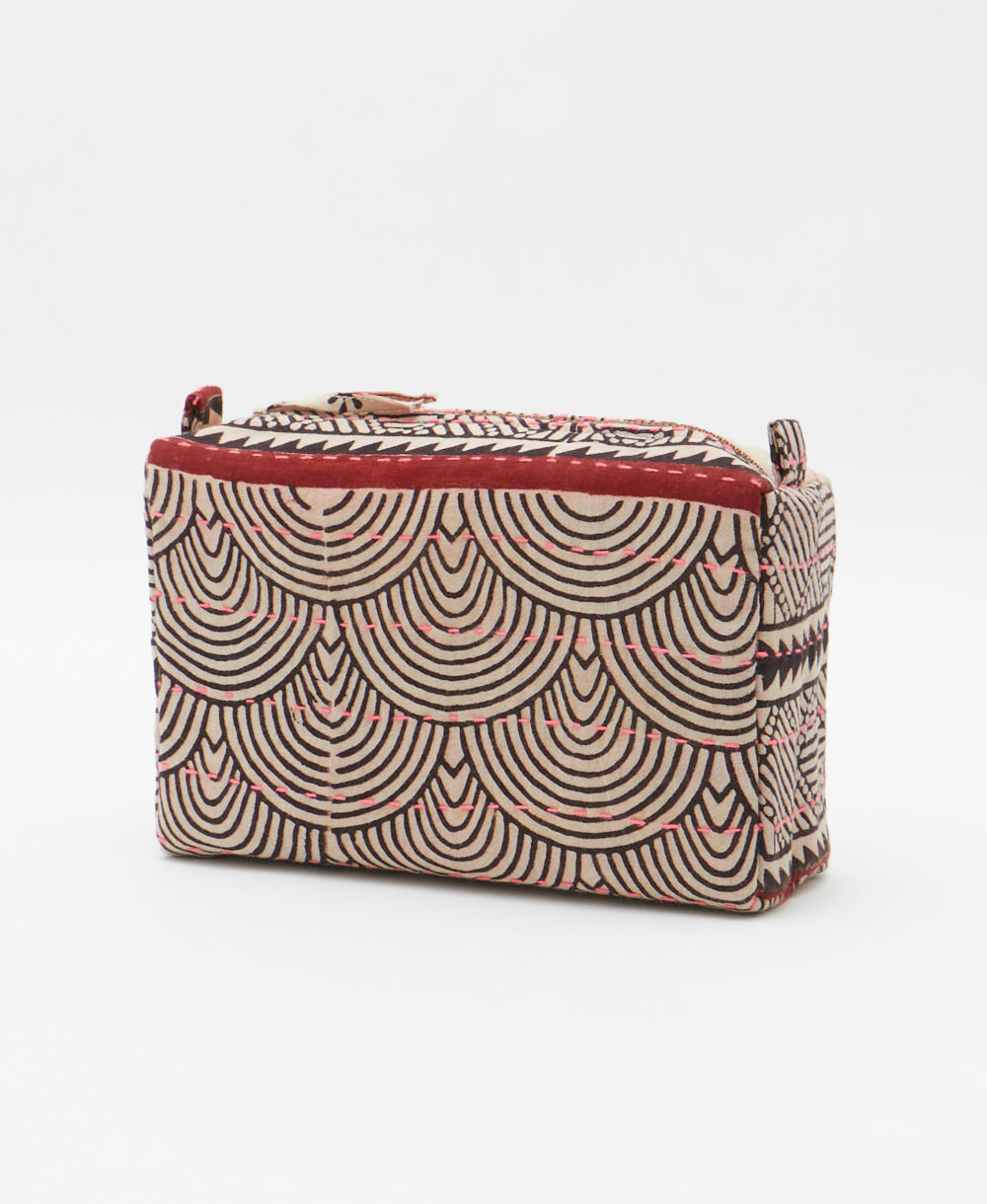 cosmetic travel bag in a white & black geometric print with neon pink hand-stitched kantha embroidery