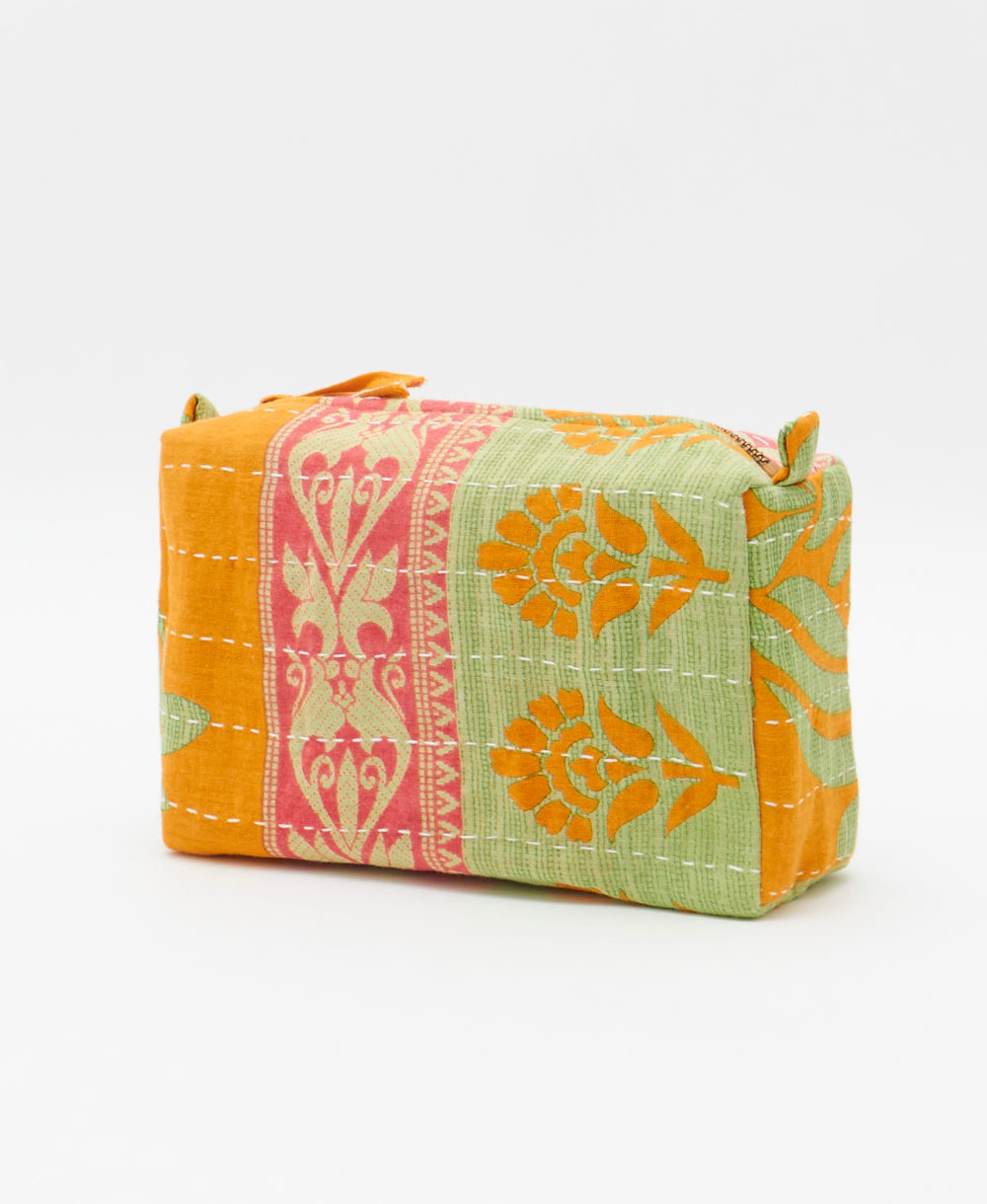 cosmetic travel bag in an orange & pastel green floral print with white hand-stitched kantha embroidery