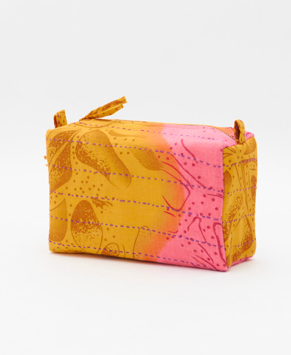 cosmetic travel bag in an orange & pink abstract print with purple hand-stitched kantha embroidery