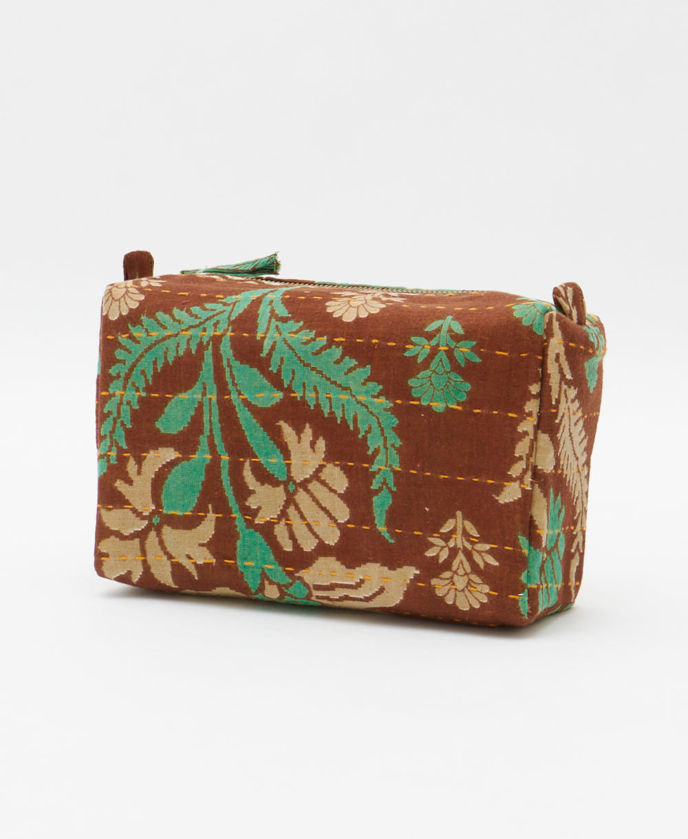 cosmetic travel bag in a brown & green floral print with orange hand-stitched kantha embroidery