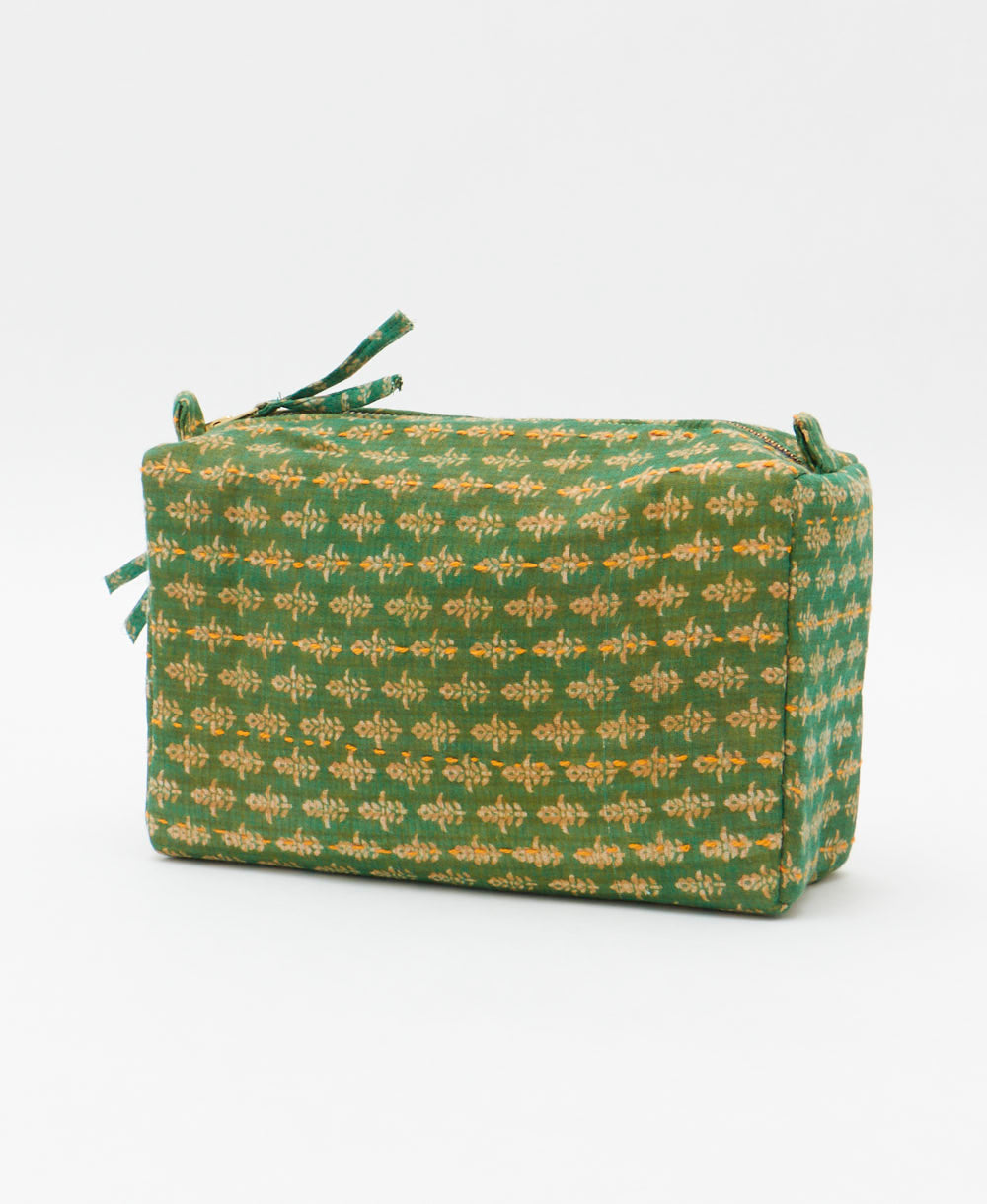 cosmetic travel bag in a grass green & tan floral print with blue hand-stitched kantha embroidery