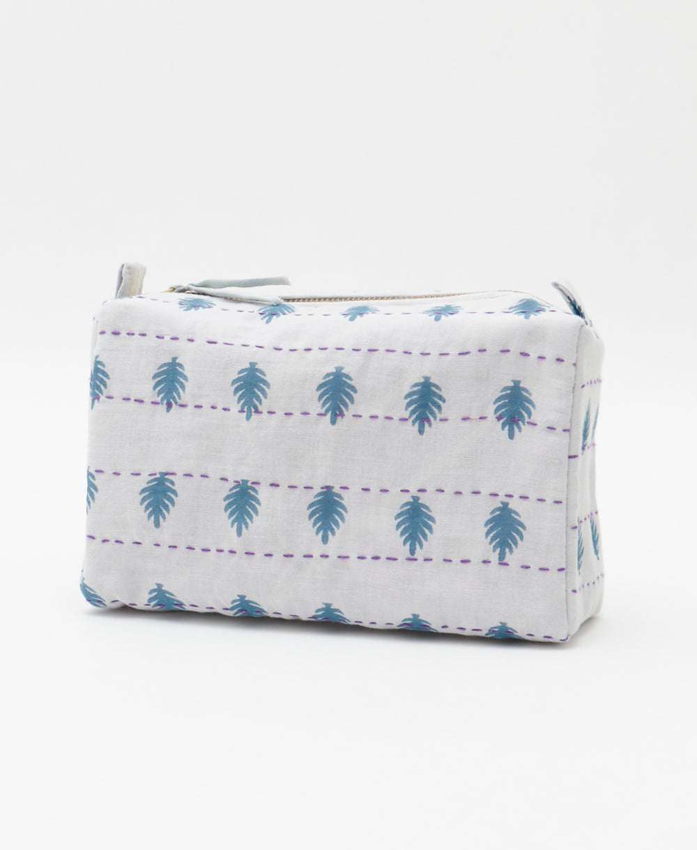 cosmetic travel bag in a white & slate blue leaf print with purple hand-stitched kantha embroidery