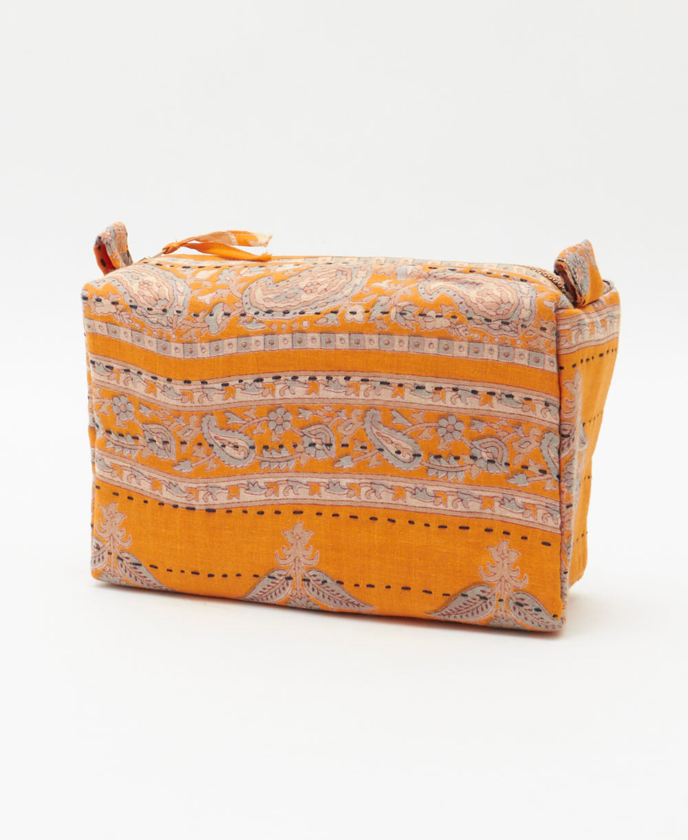 sustainable cosmetic travel bag in orange and grey paisley print with hand-embroidery