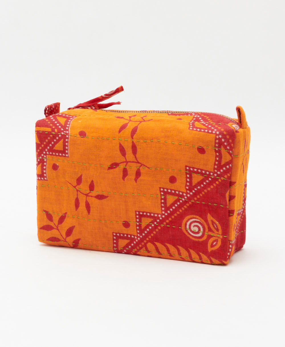 eco-friendly cosmetic travel bag in red and orange leaf print made from vintage fabrics with hand-embroidery