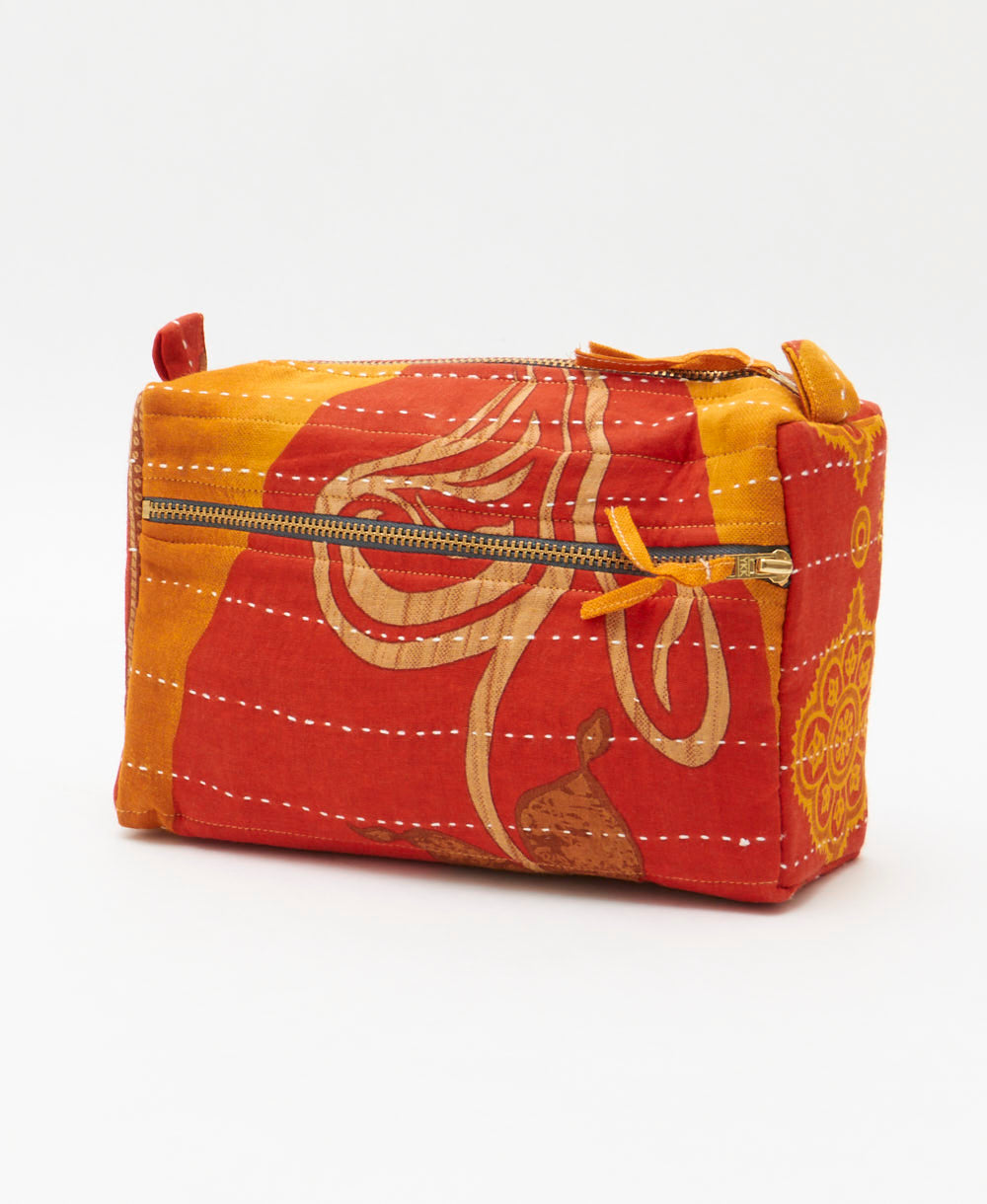 sunset orange medium toiletry bag with golden yellow and tan abstract print