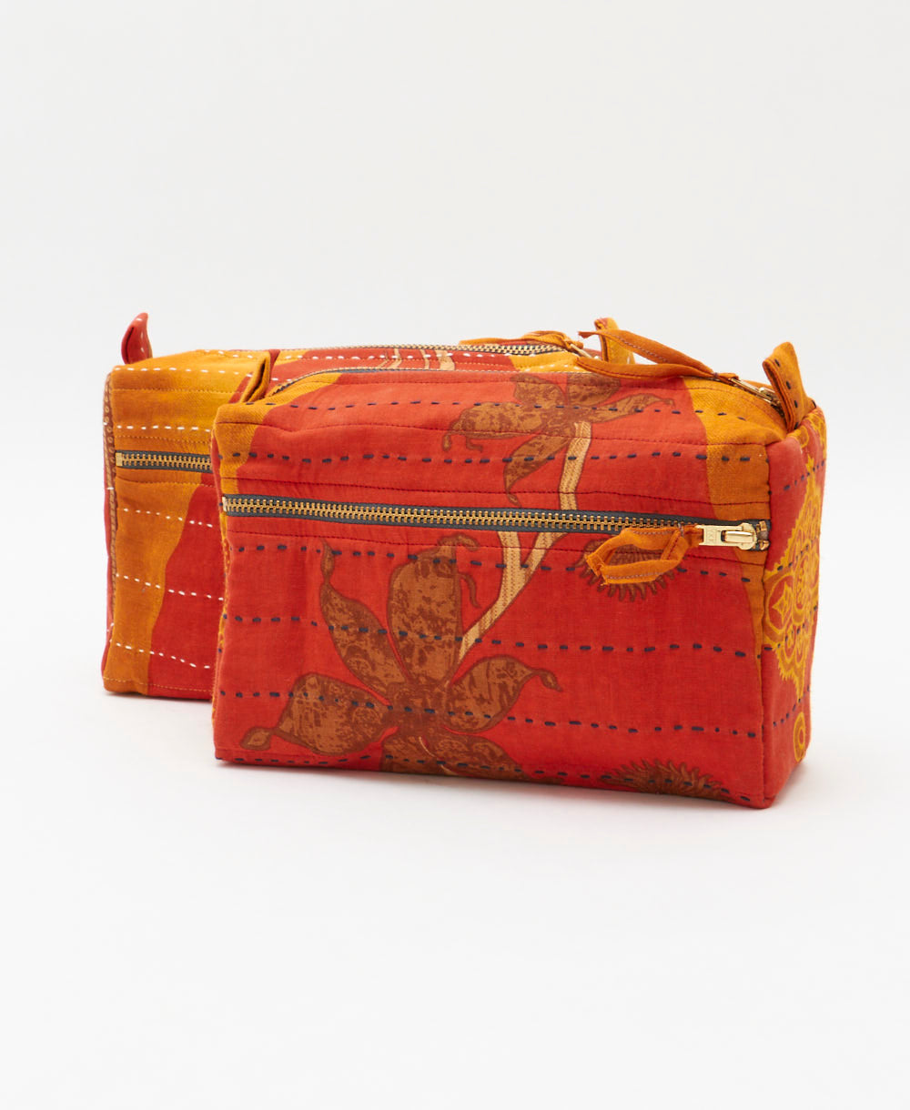 small makeup bag in dark orange and bold yelloe abstract print with hand-stitched embroidery