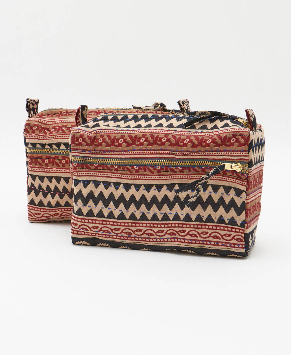 small makeup bag in a red, tan and black stripe print handmade in India by women artisans