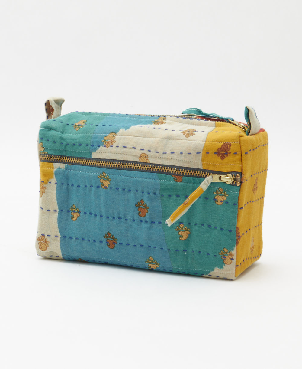 teal medium toiletry bag in golden yellow colorblock print with tiny flowers handmade in India by women artisans