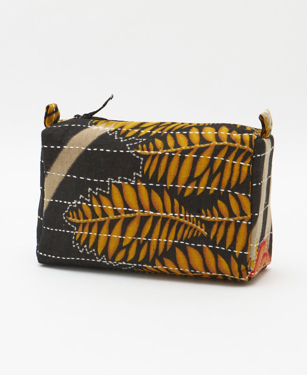 sustainable cosmetic travel bag in black and golden yellow fern print