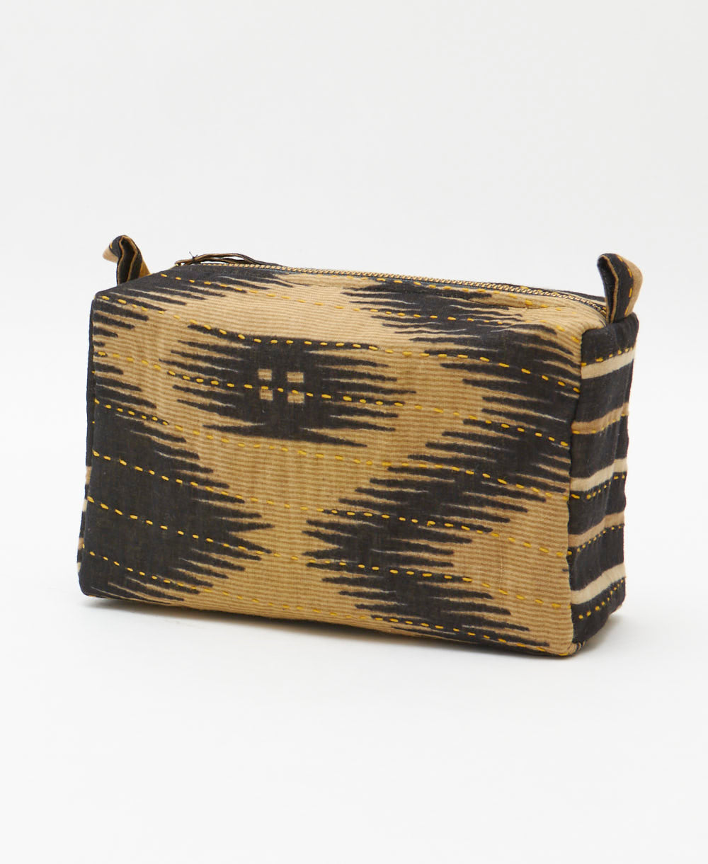 cosmetic travel bag in black and tan southwestern print with hand-stitched embroidery