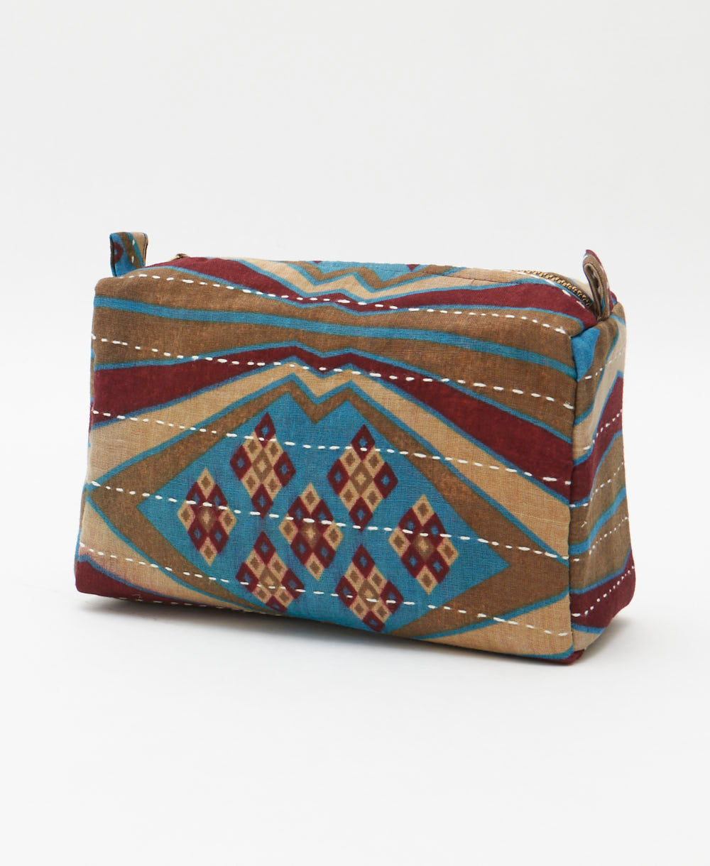 cosmetic travel bag in a maroon, turquoise and tan abstract print handmade in India