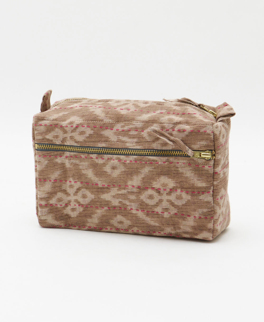 southwestern print medium toiletry bag in sandy beige hues with pink hand-stitched embroidery