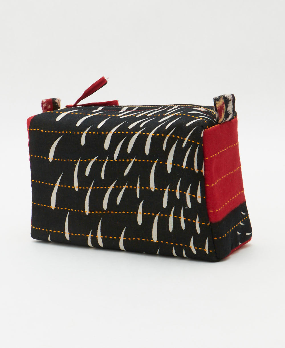 sustainable cosmetic travel bag in black, hot pink and golden yellow floral print