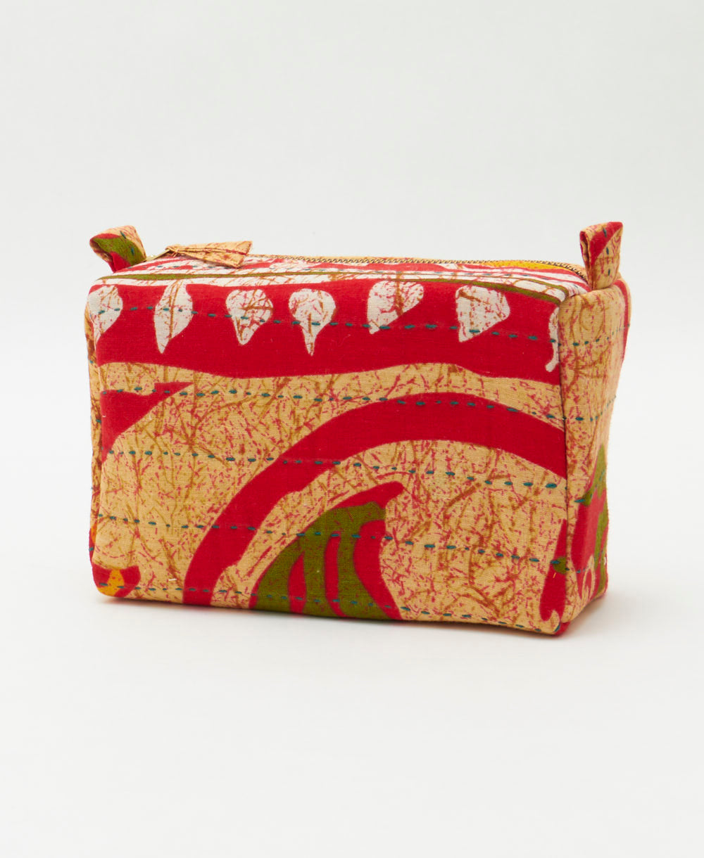 tan cosmetic travel bag with bold red and orange abstract print and green embroidery handmade in India