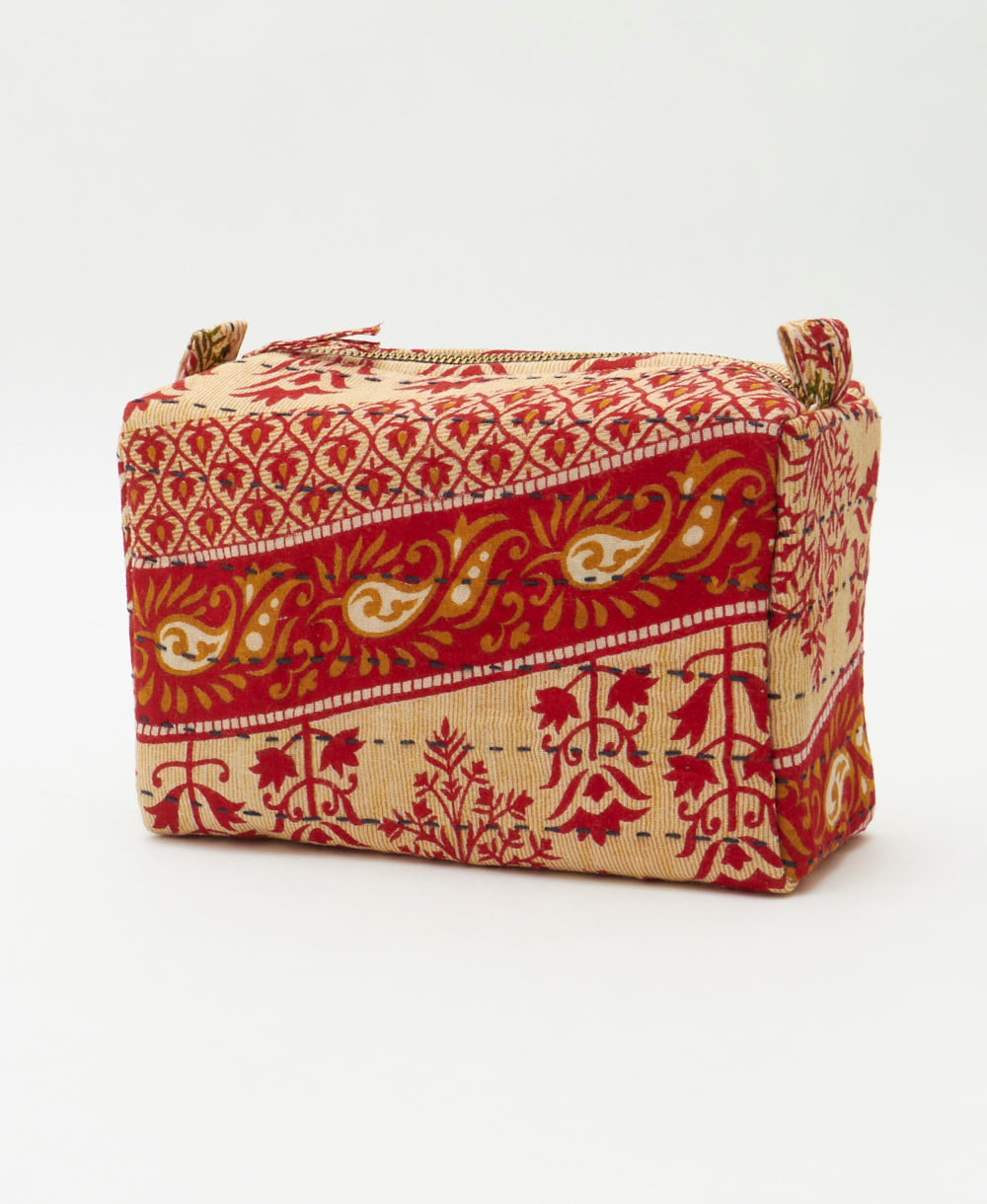 tan & red cosmetic travel bag featuring a bold floral print