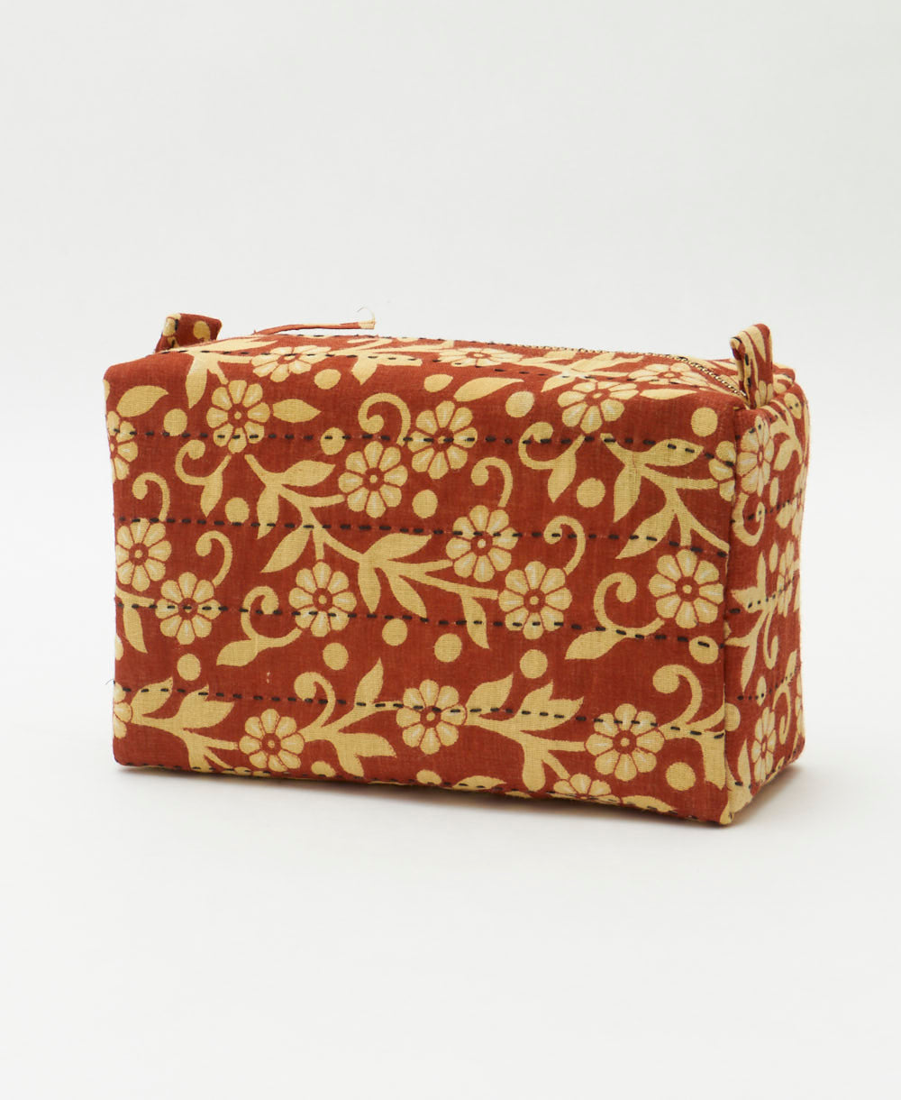 rust orange cosmetic travel bag with pastel yellow floral pattern & 2 zipper closures