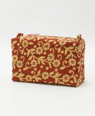 rust orange cosmetic travel bag with pastel yellow floral pattern & 2 zipper closures