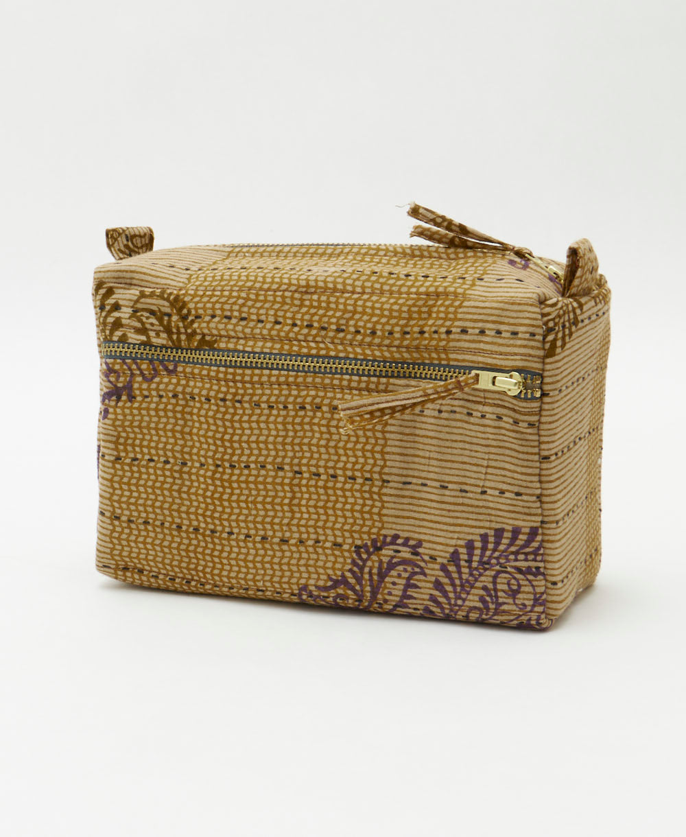 light brown medium toiletry bag in a subtle stripe print with eggplant purple paisley accents