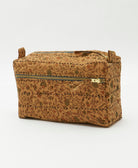 light brown medium toiletry bag in a tiny woodsy floral print