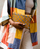 Woman holding vintage kantha pouch clutch getting ready for
a night out