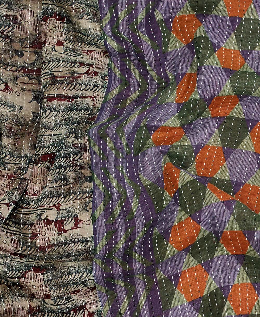 neutral kantha quilt throw with a tag featuring the hand-stitched signature of the maker