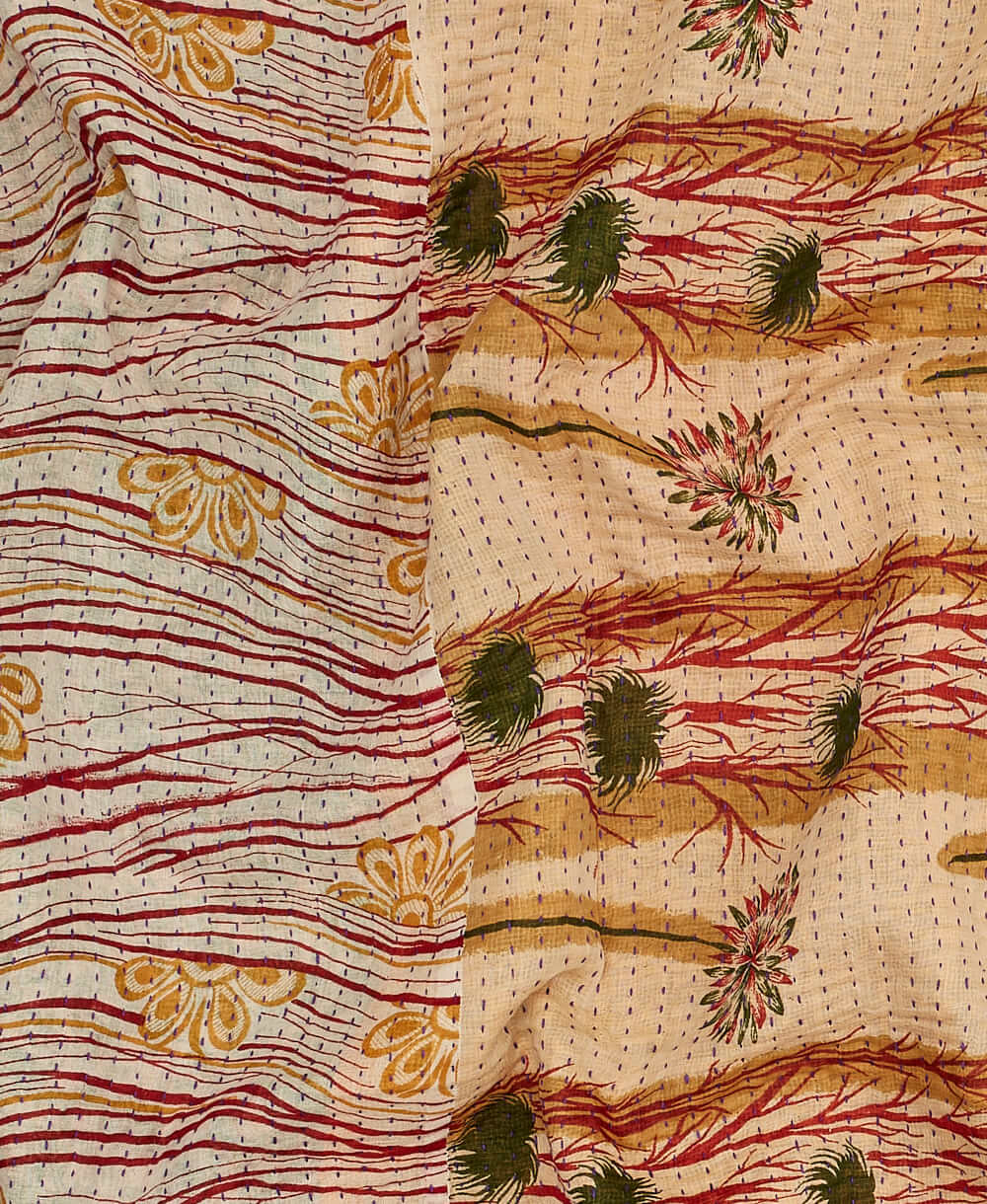 Beige kantha quilt throw with a tag featuring the hand-stitched signature of the maker