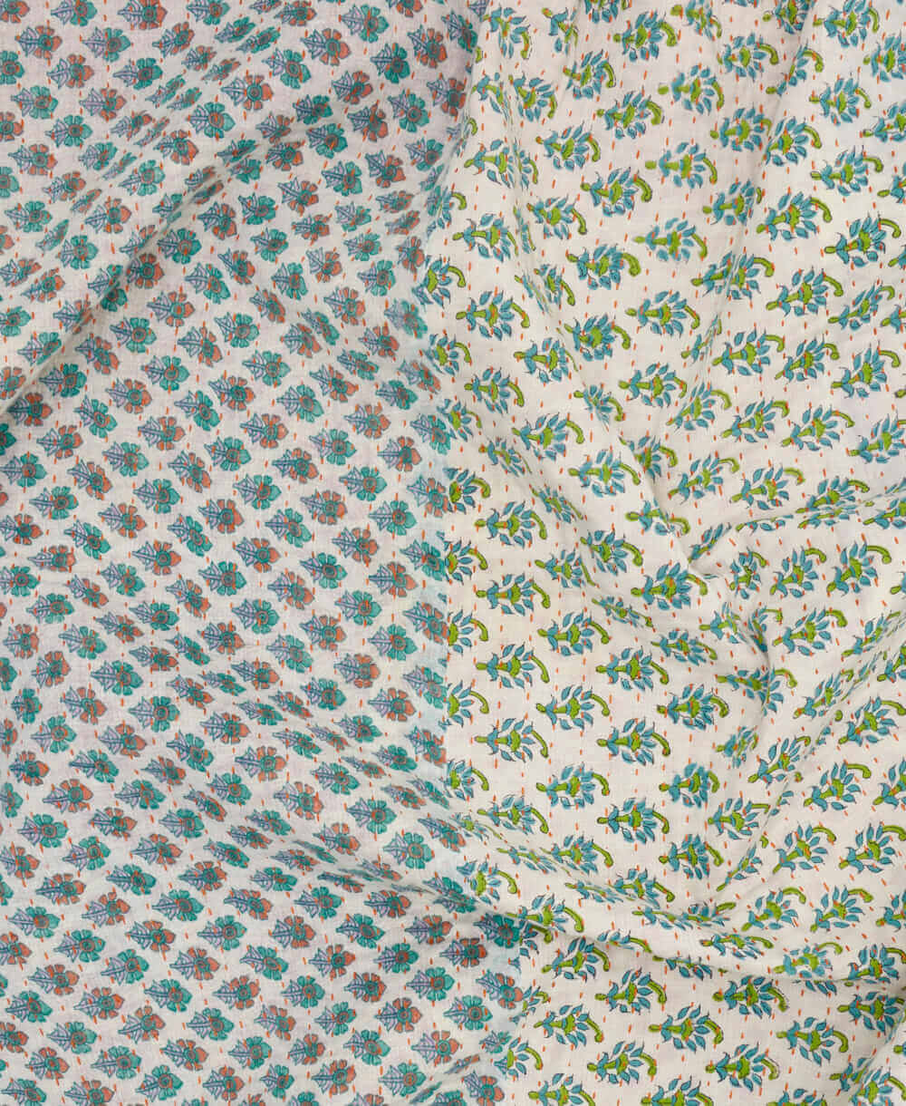 sage and lavender kantha quilt throw with a tag featuring the hand-stitched signature of the maker