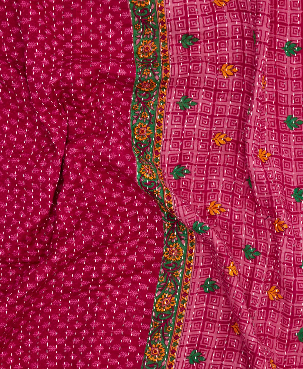 dark pink kantha quilt throw with a tag featuring the hand-stitched signature of the maker