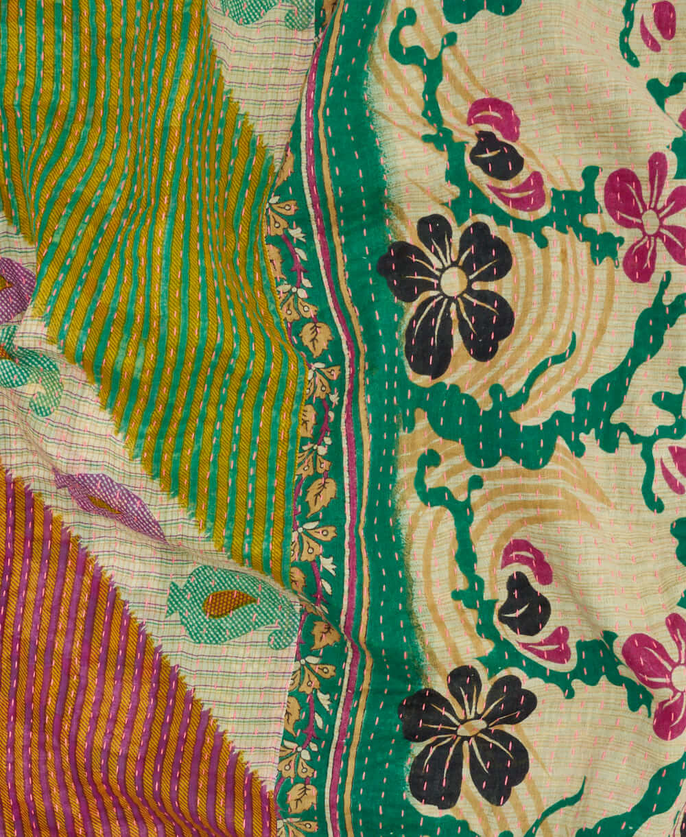 teal and purple paisley stripe kantha quilt throw with a tag featuring the hand-stitched signature of the maker