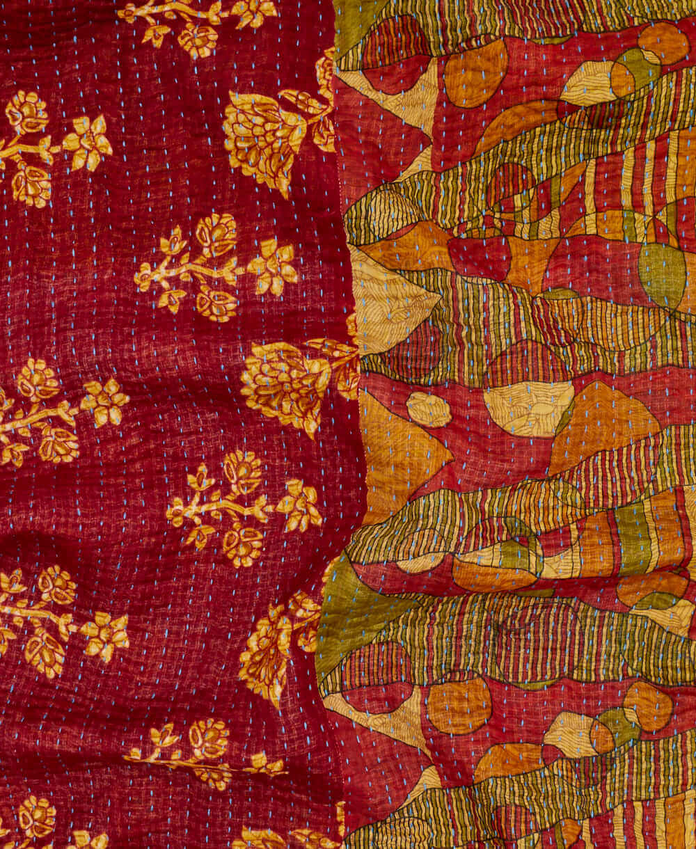 marron abstract kantha quilt throw with a tag featuring the hand-stitched signature of the maker