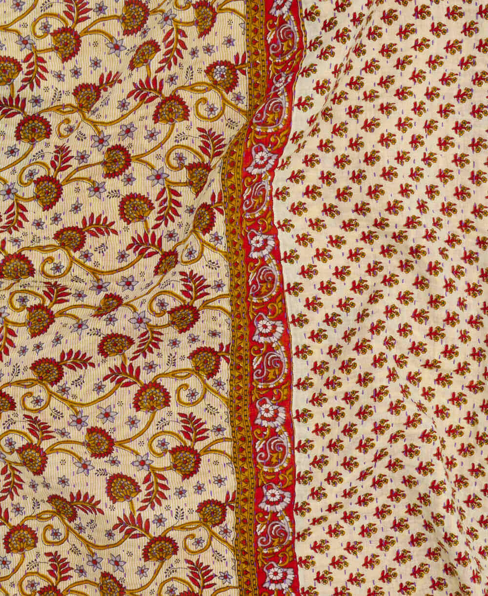  red vine kantha quilt throw with a tag featuring the hand-stitched signature of the maker